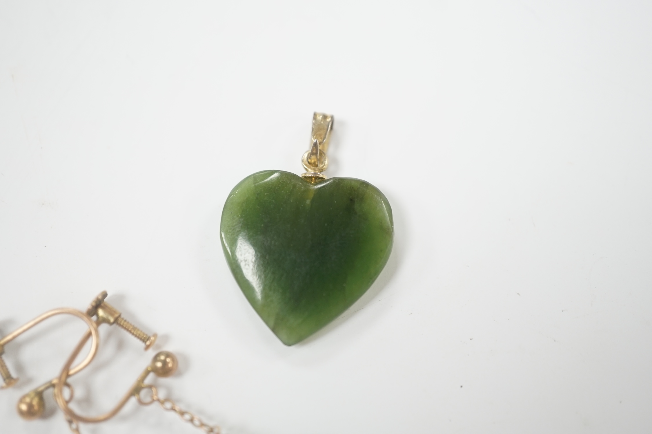 A gilt metal mounted nephrite heart shape pendant, 20mm and a pair of simulated jade earrings.